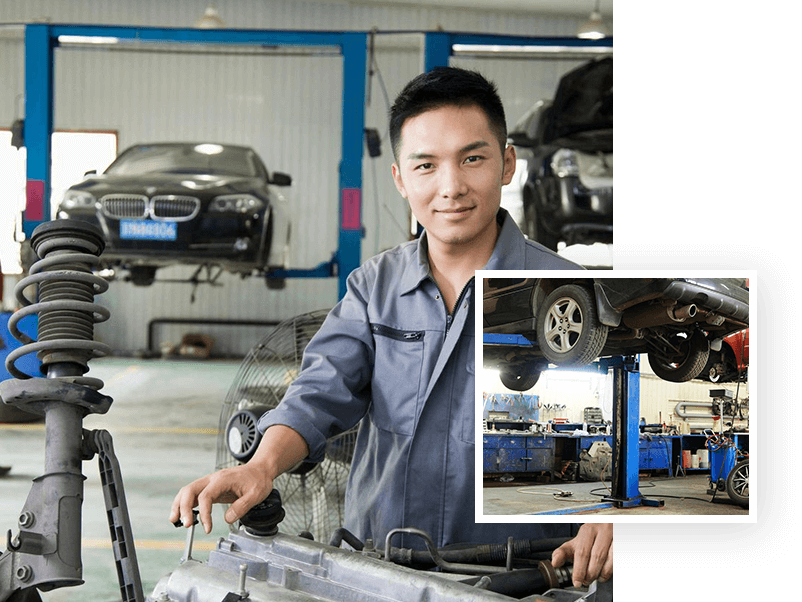 A man in a garage with some cars