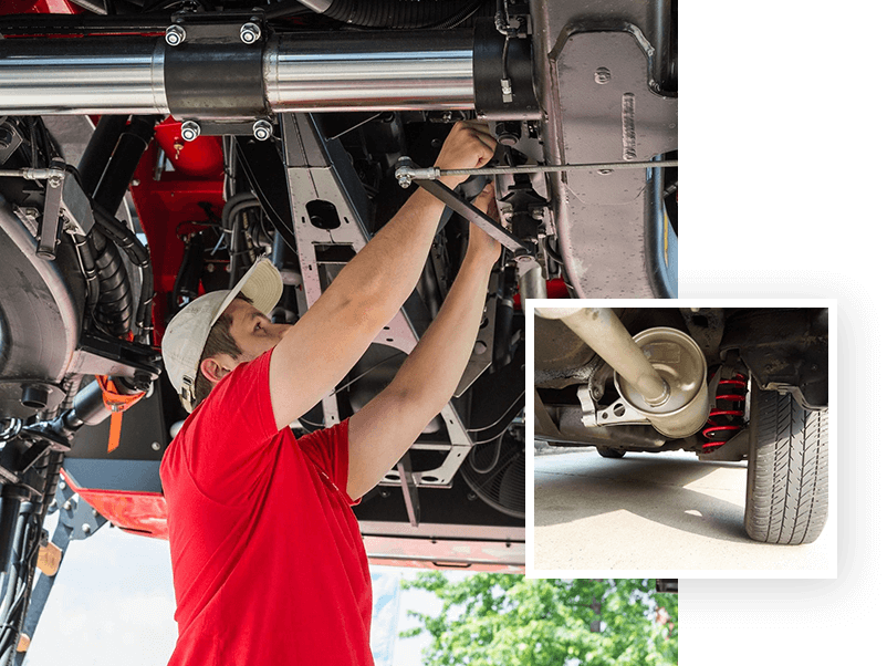 A man working on the underside of an automobile.