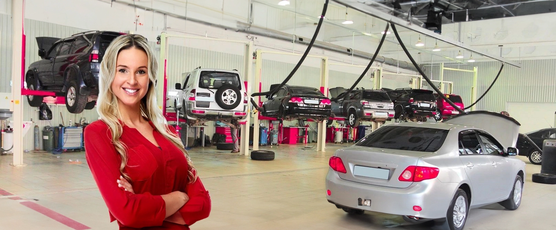 A man in red jacket standing next to cars.